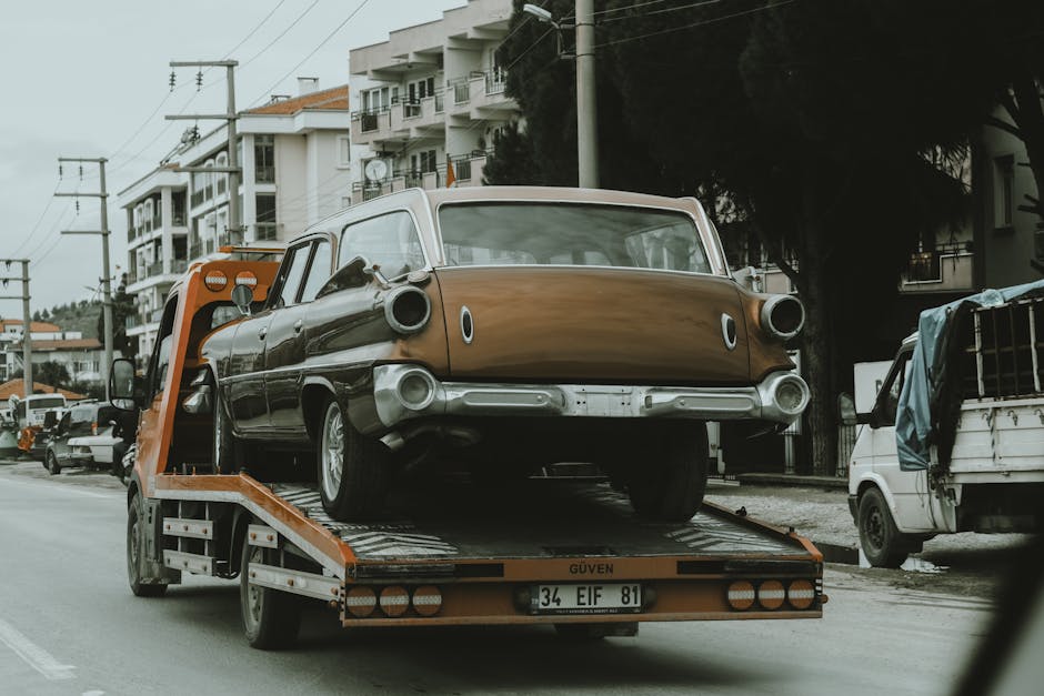 Professional red and white towing truck on highway performing vehicle recovery